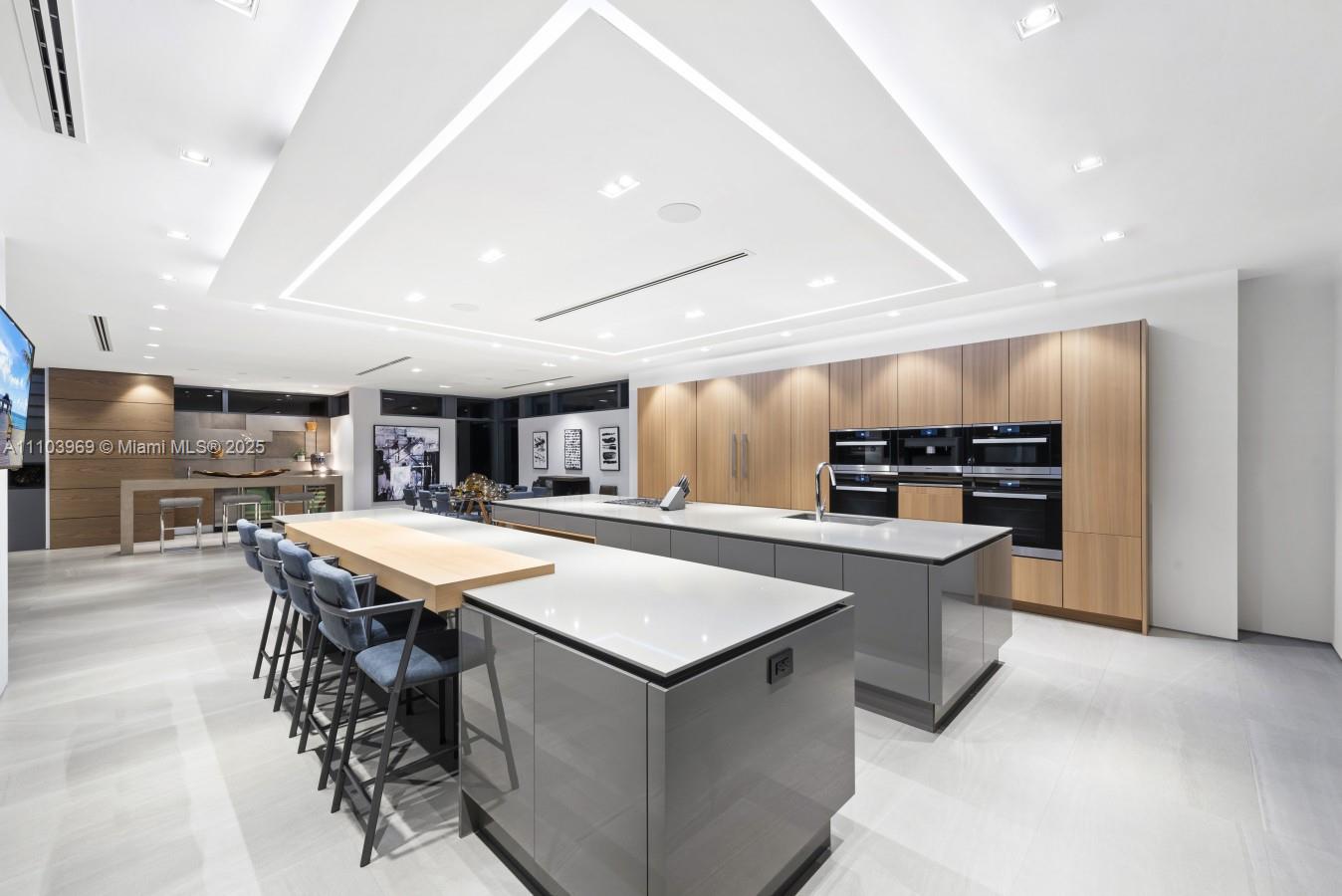 440 Mola Avenue Fort Lauderdale, FL 33301 - Photo 16 of 66 a kitchen with stainless steel appliances kitchen island a large island in the center
