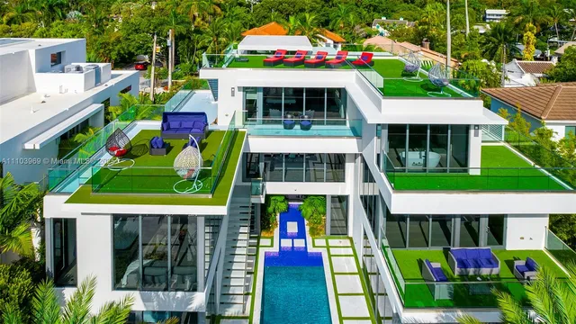 a large bedroom with a bed and wooden floor