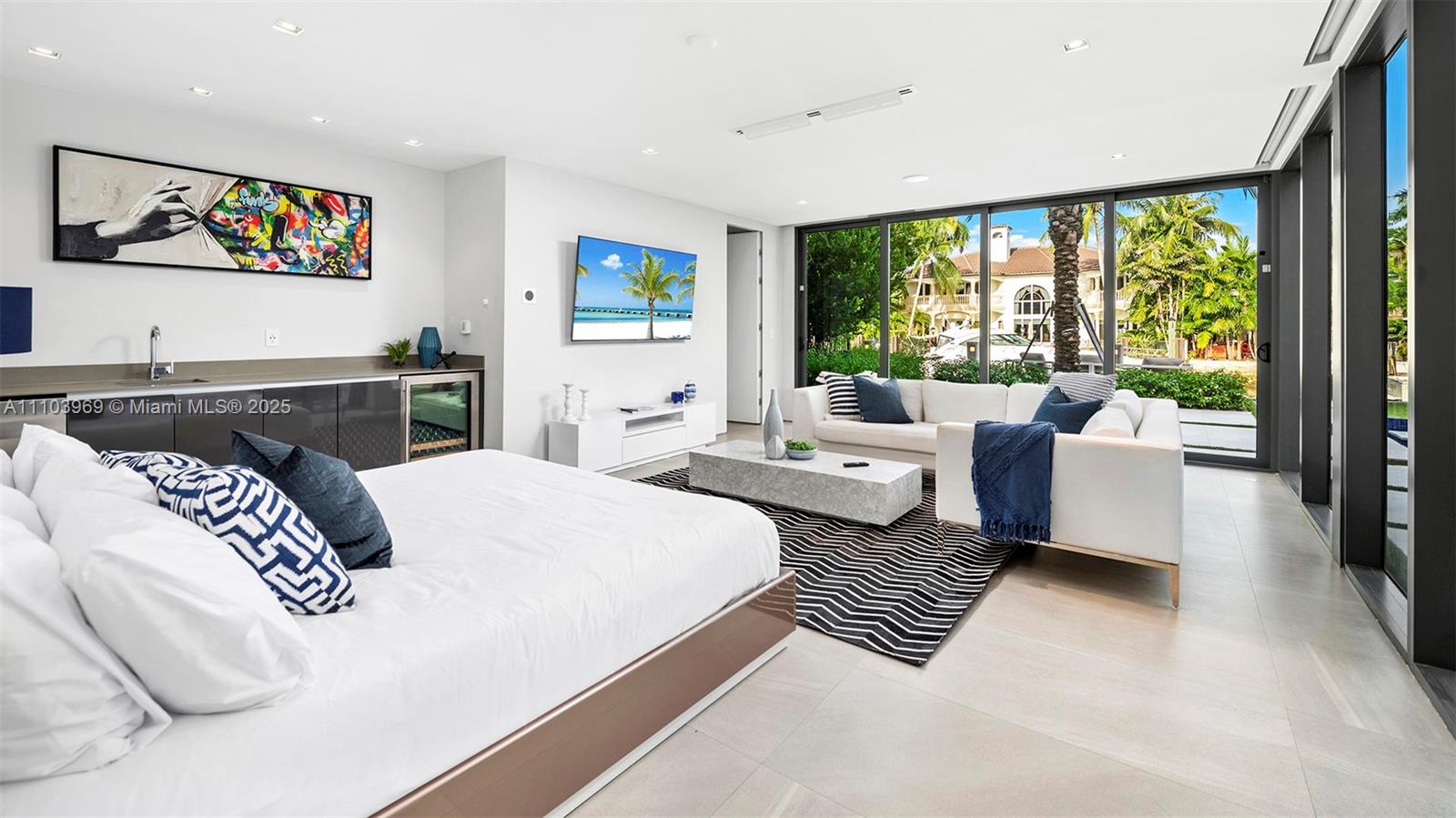 440 Mola Avenue Fort Lauderdale, FL 33301 - Photo 41 of 66 a bedroom with a bed and glass door