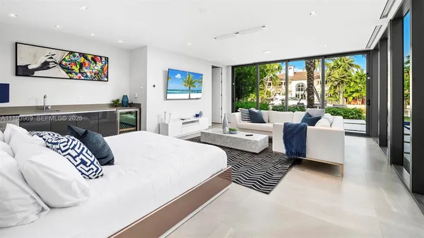 a bedroom with a large bed and a large window