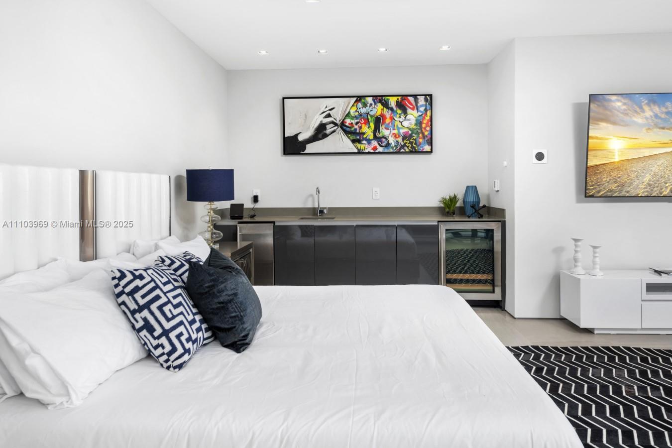 440 Mola Avenue Fort Lauderdale, FL 33301 - Photo 43 of 66 a large bedroom with a bed and wooden floor