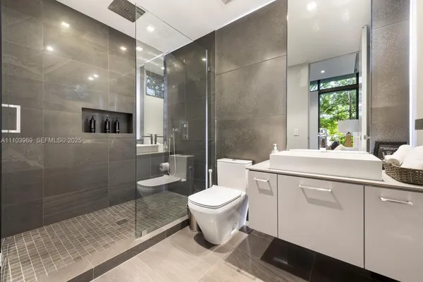 a bedroom with a large bed and a large window