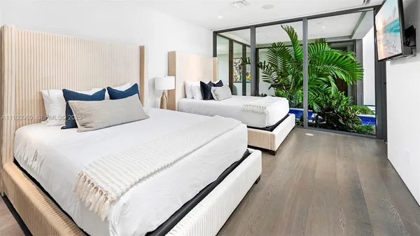 a bedroom with a bed and a large window