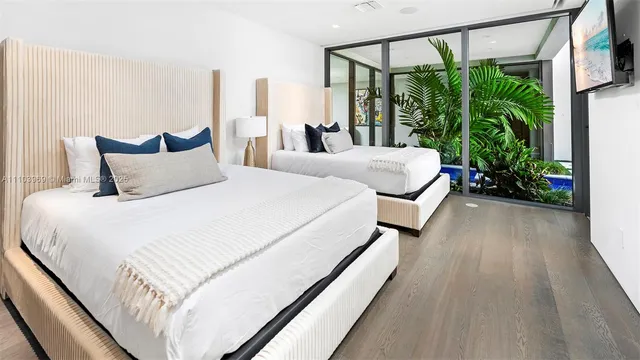 a bedroom with a large bed and a large window