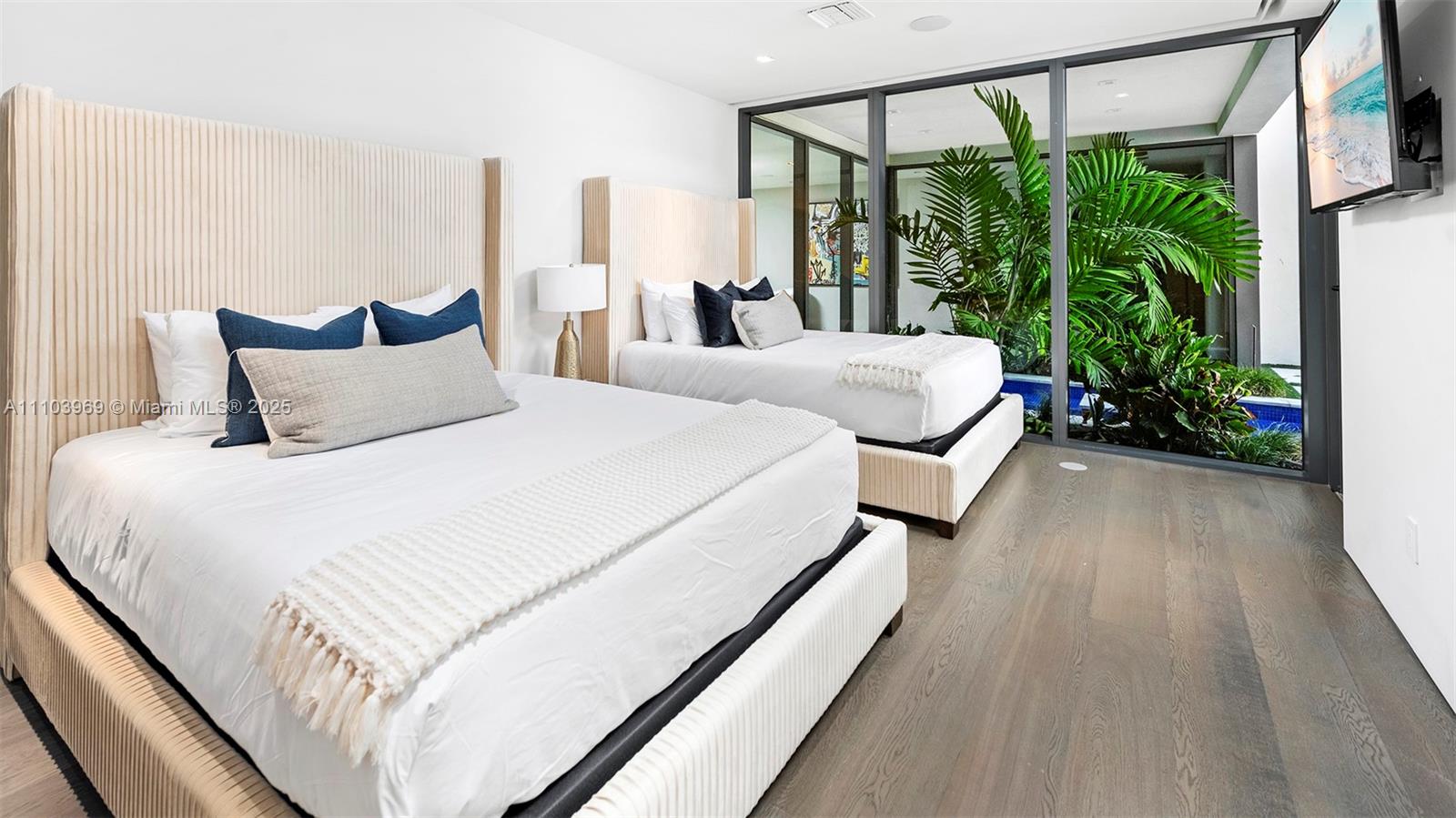 440 Mola Avenue Fort Lauderdale, FL 33301 - Photo 45 of 66 a large bed sitting in a bedroom next to a window