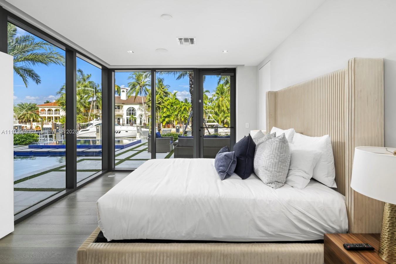 440 Mola Avenue Fort Lauderdale, FL 33301 - Photo 50 of 66 a bedroom with a large bed and a large window