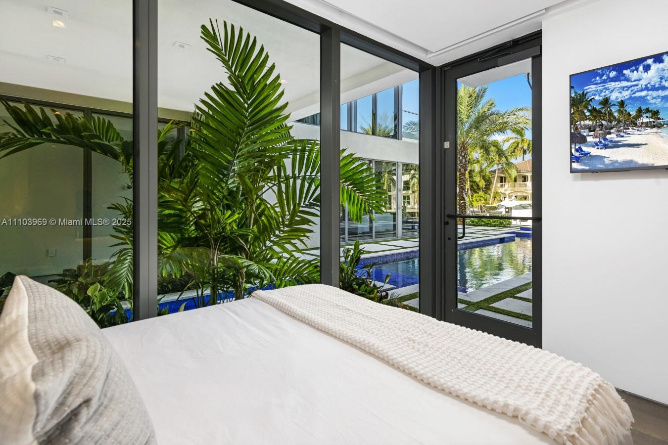 440 Mola Avenue Fort Lauderdale, FL 33301 - Photo 54 of 66 a bedroom with a bed and a large window