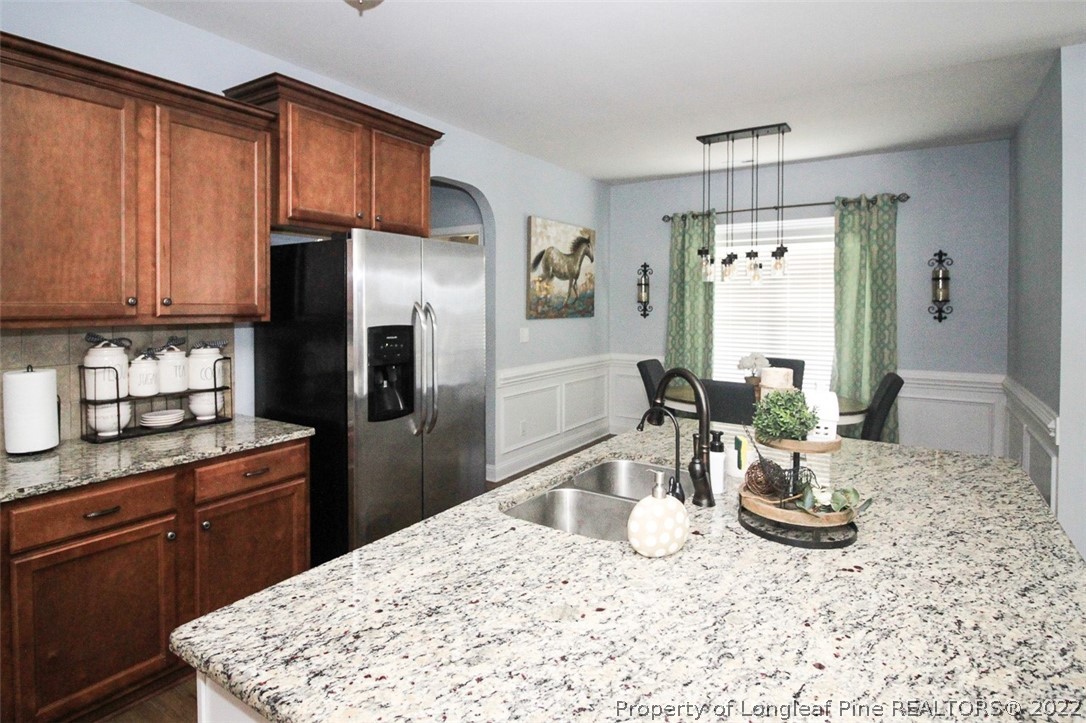 3549 Thrower Road Hope Mills, NC 28348 - Photo 12 of 38 a kitchen with granite countertop a refrigerator stove top oven and sink