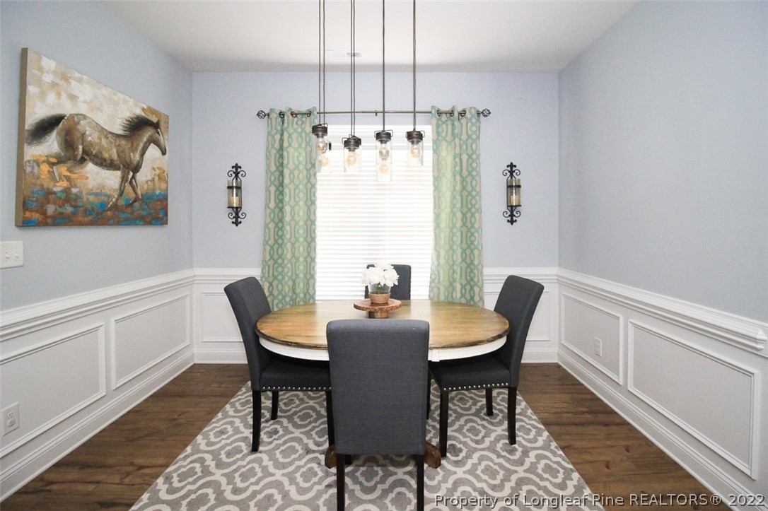 3549 Thrower Road Hope Mills, NC 28348 - Photo 14 of 38 a view of a dining room with furniture window and wooden floor