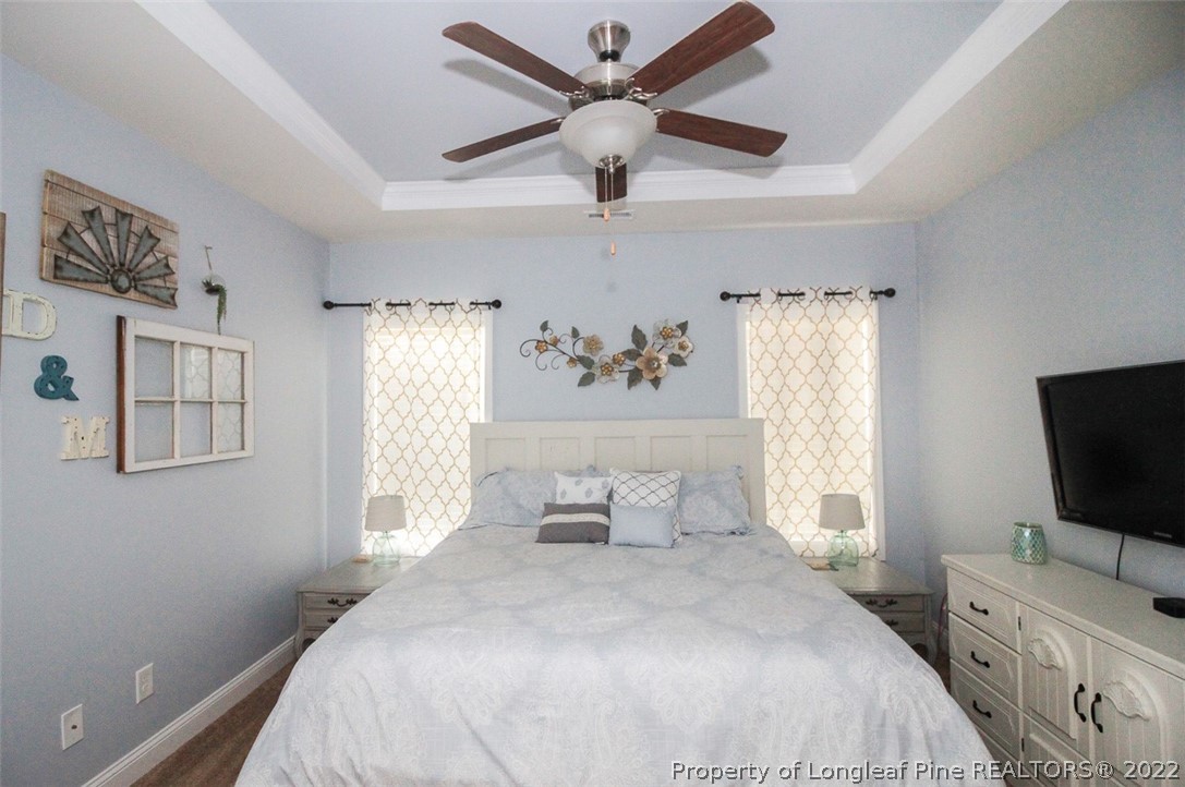 3549 Thrower Road Hope Mills, NC 28348 - Photo 17 of 38 a bedroom with a bed and a flat tv screen on the dresser