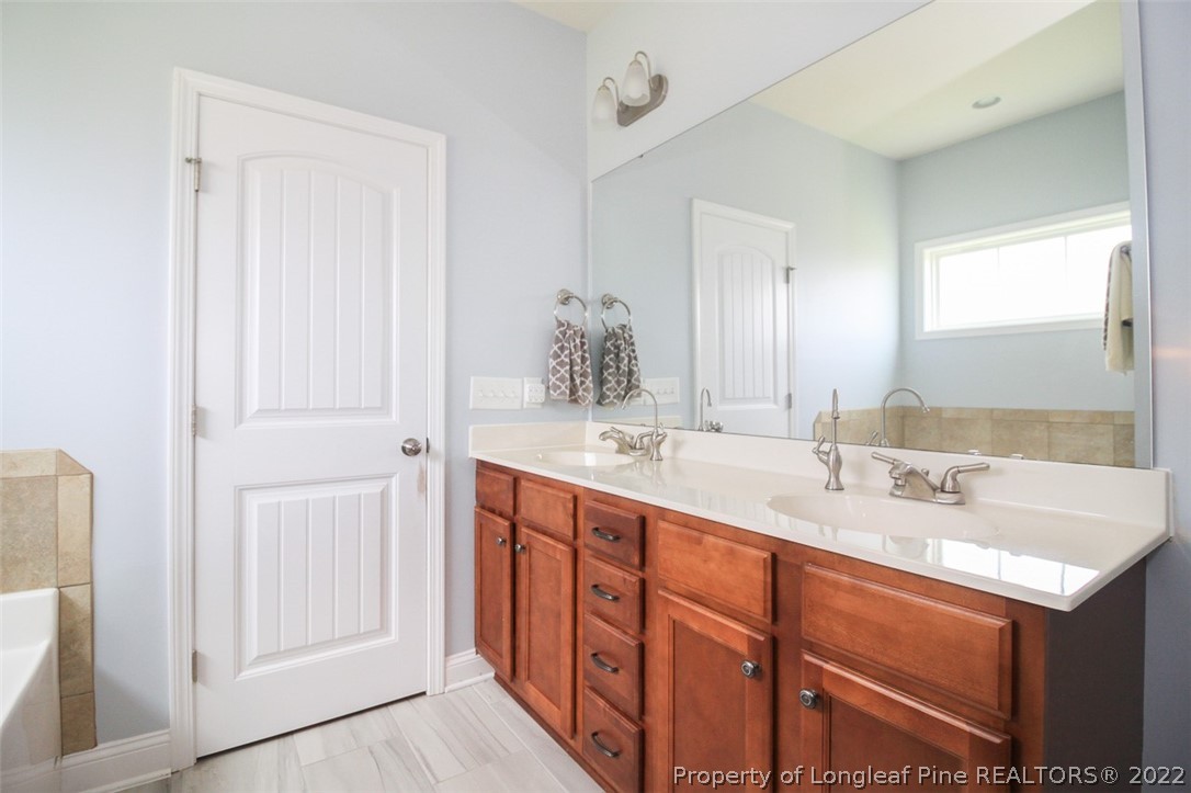 3549 Thrower Road Hope Mills, NC 28348 - Photo 19 of 38 a bathroom with a double vanity sink and a mirror
