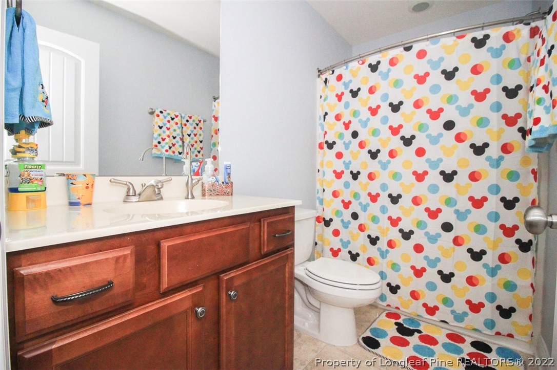 3549 Thrower Road Hope Mills, NC 28348 - Photo 25 of 38 a bathroom with a sink and mirror with toilet