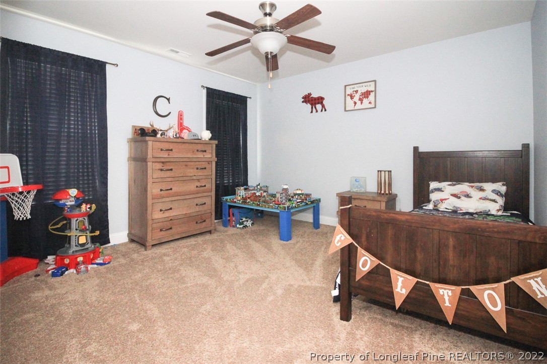 3549 Thrower Road Hope Mills, NC 28348 - Photo 26 of 38 a bedroom with a bed and a chandelier