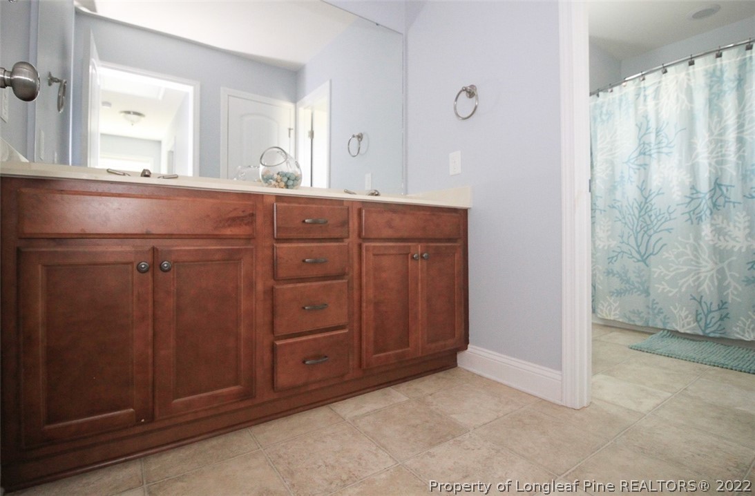 3549 Thrower Road Hope Mills, NC 28348 - Photo 30 of 38 a bathroom with a granite countertop sink and a mirror