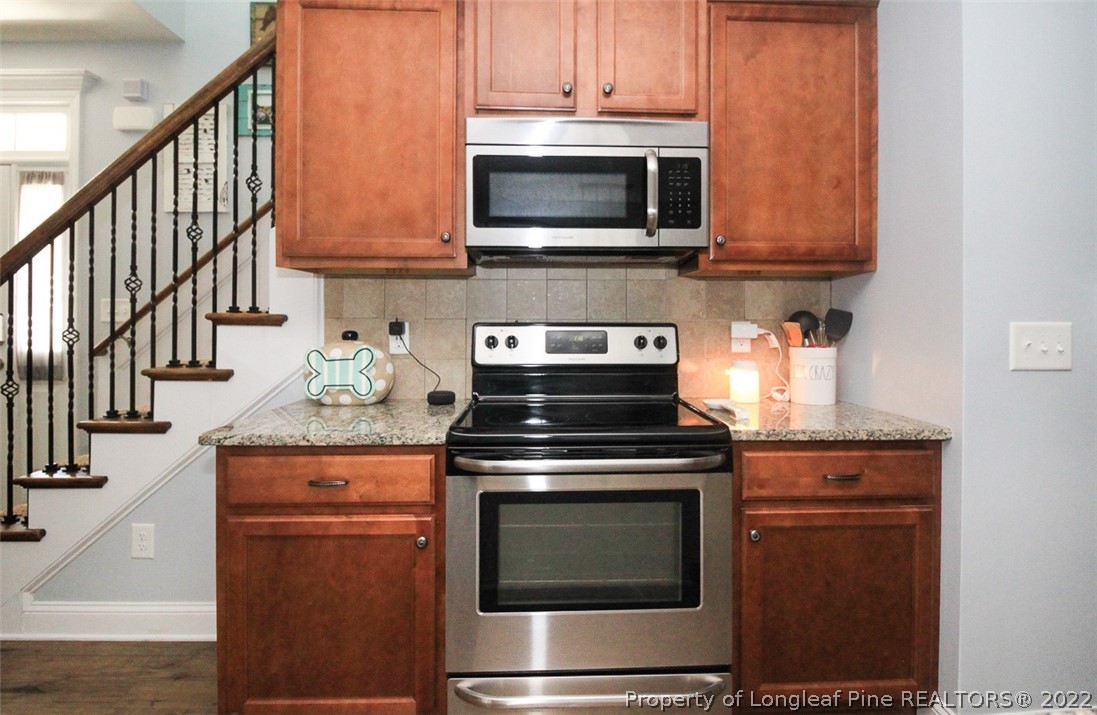 3549 Thrower Road Hope Mills, NC 28348 - Photo 10 of 38 a kitchen with stainless steel appliances granite countertop a stove and a microwave