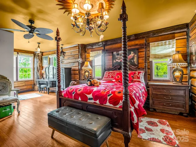 a bed room with a bed next to a window