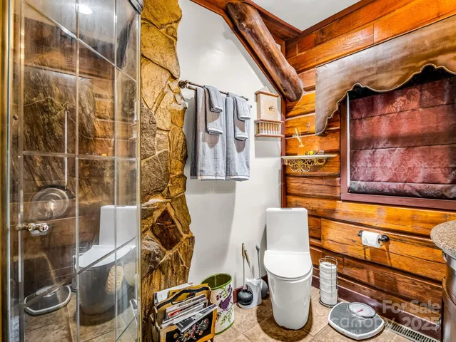 a bathroom with a toilet and a shower