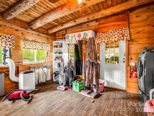 a view of gym equipment with wooden floor