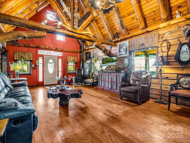 a living room with fireplace furniture and a large window