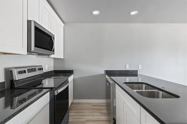a kitchen that has a sink and a stove