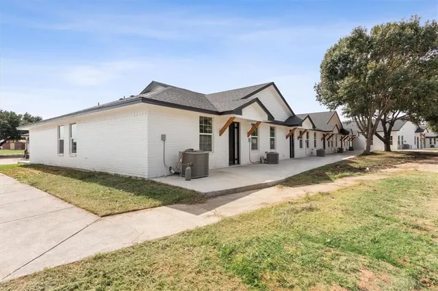 a view of a house with snow on the road