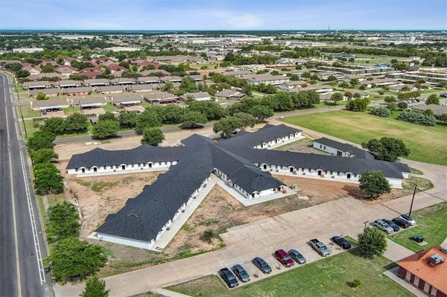 an aerial view of residential houses with outdoor space