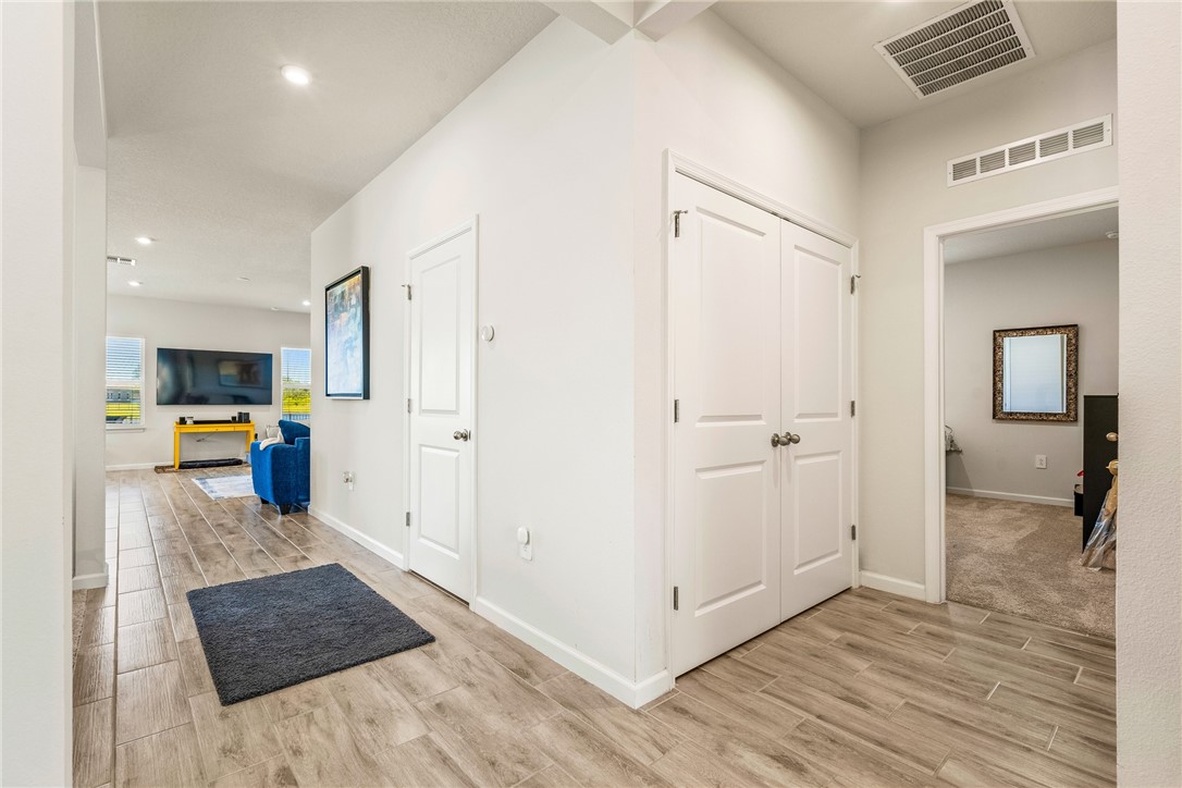 4202 Keeson Circle Vero Beach, FL 32967 - Photo 29 of 36 a view of a hallway with wooden floor and furniture