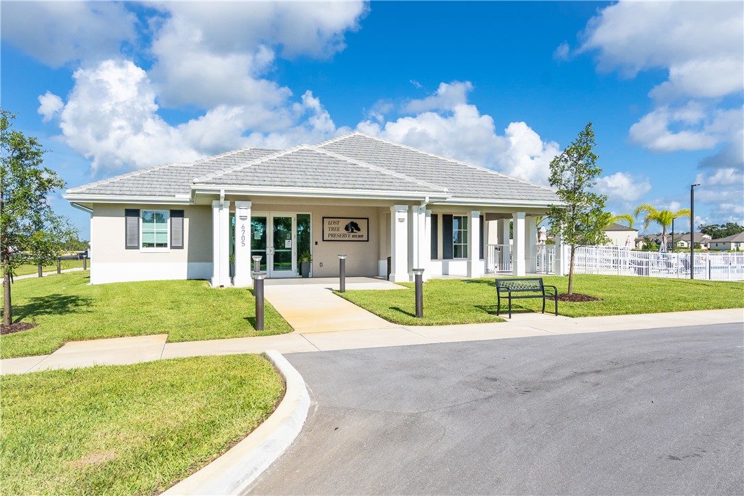 4202 Keeson Circle Vero Beach, FL 32967 - Photo 35 of 36 a view of yellow house with a big yard and potted plants