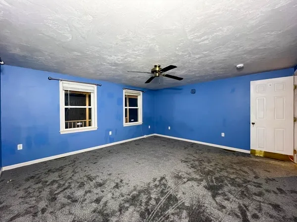 a view of an empty room with windows