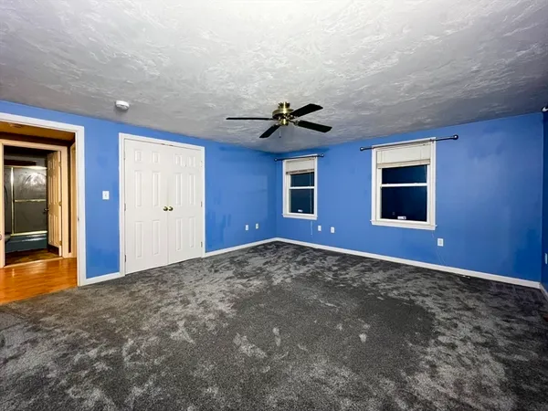 a view of a livingroom with a ceiling fan and window