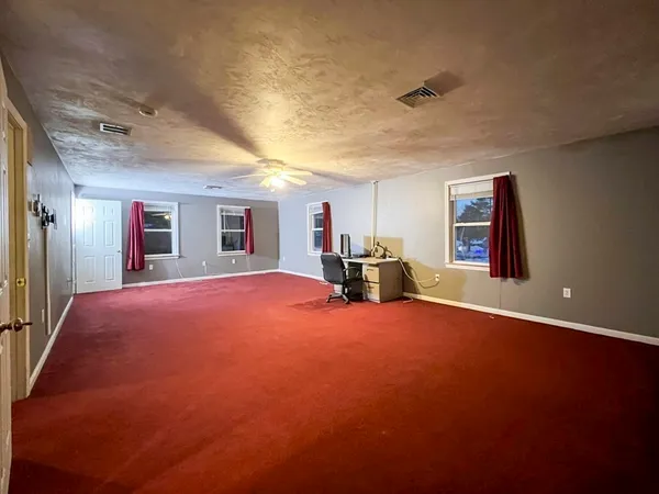 a view of empty room with windows