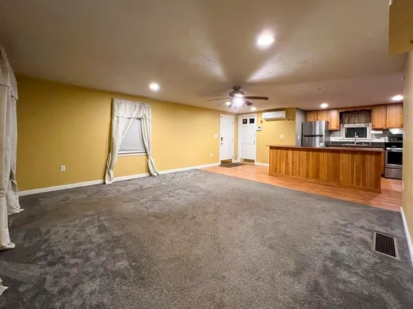 a view of a room with a kitchen