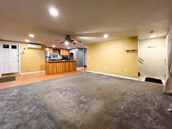an empty room with a kitchen and a sink