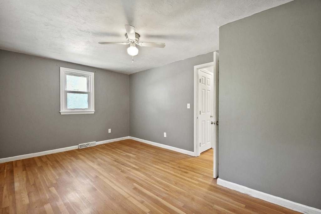 40 Orton Street Worcester, MA 01604 - Photo 11 of 28 a view of an empty room with wooden floor and a window