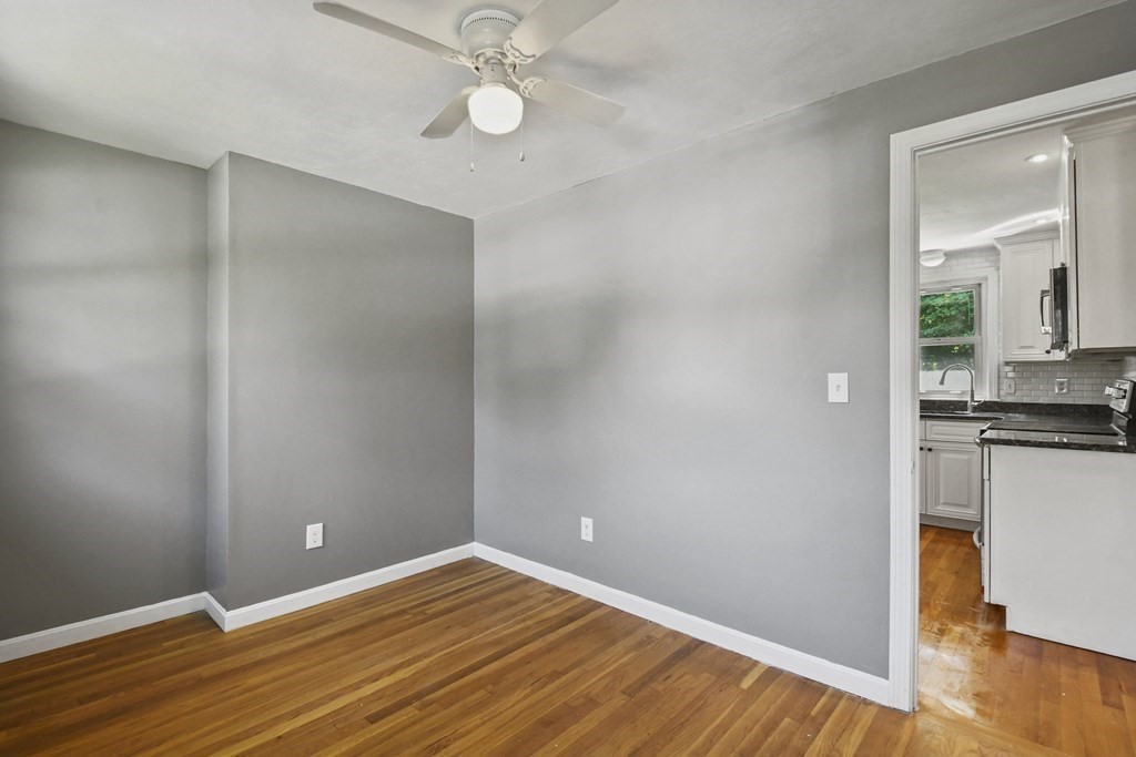 40 Orton Street Worcester, MA 01604 - Photo 15 of 28 a view of a kitchen with wooden floor and a ceiling fan