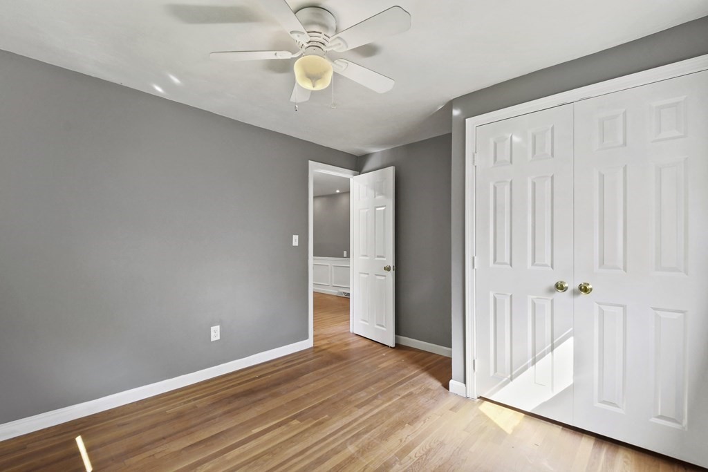 40 Orton Street Worcester, MA 01604 - Photo 20 of 28 an empty room with wooden floor and ceiling fan