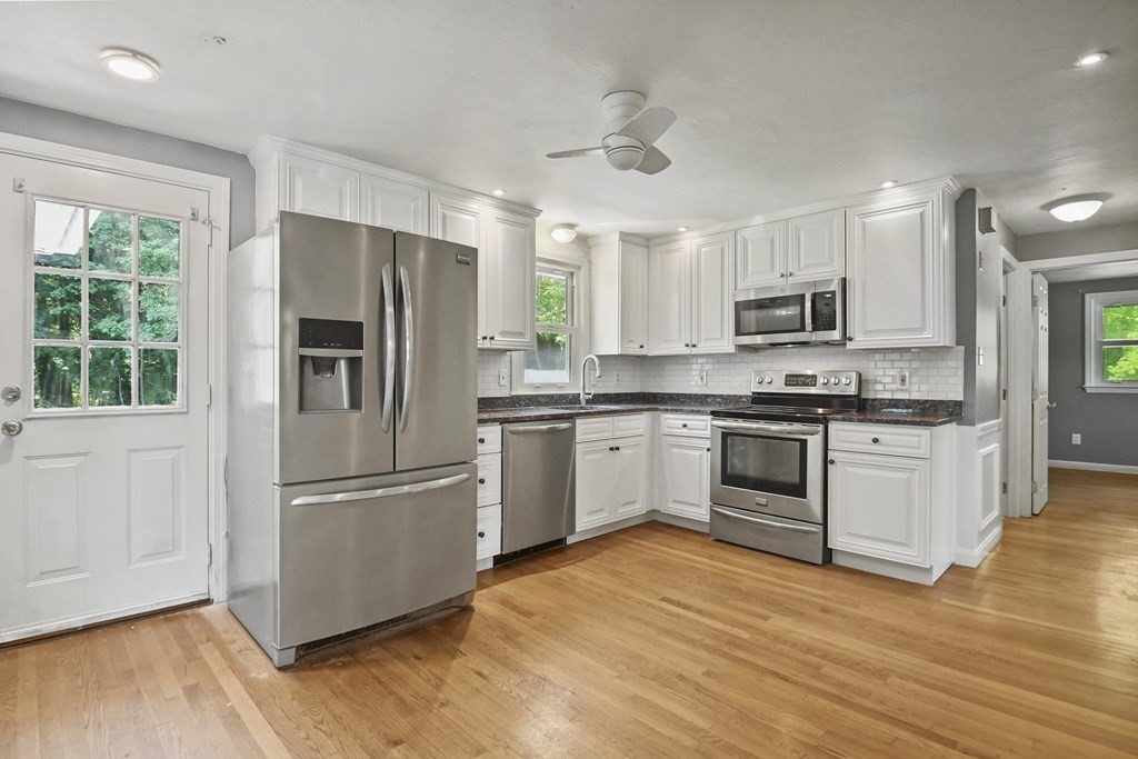 40 Orton Street Worcester, MA 01604 - Photo 6 of 28 a kitchen with cabinets stainless steel appliances and wooden floor