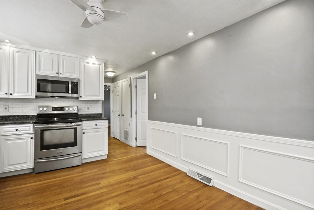 40 Orton Street Worcester, MA 01604 - Photo 8 of 28 a kitchen with granite countertop a refrigerator and a stove top oven