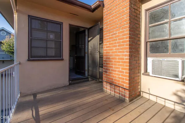 a view of front door of house with wooden floor and windows