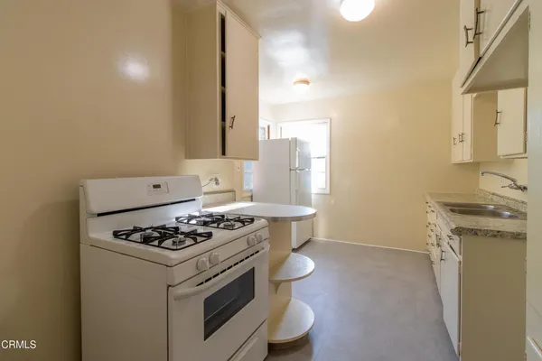 a kitchen with a stove and a sink