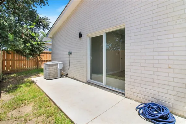 a view of back yard of the house with wooden fence