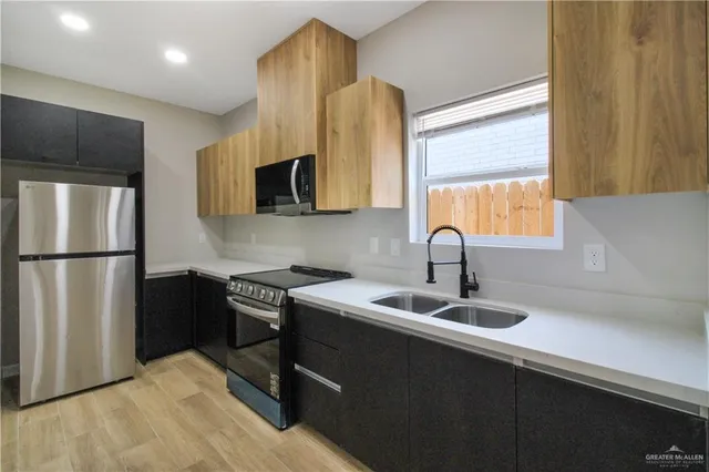 a kitchen with a refrigerator and a sink
