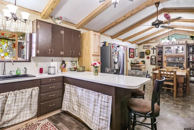 a kitchen with stainless steel appliances granite countertop a sink and cabinets