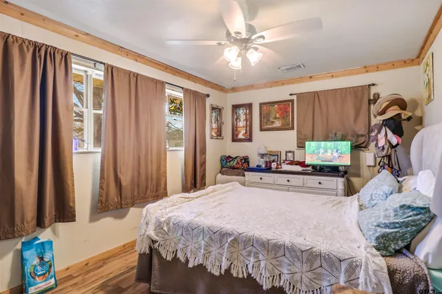 a bedroom with a bed and a chandelier