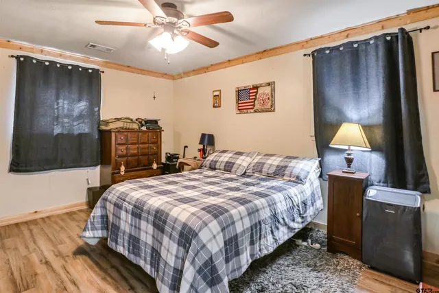 a bedroom with bed and a chandelier