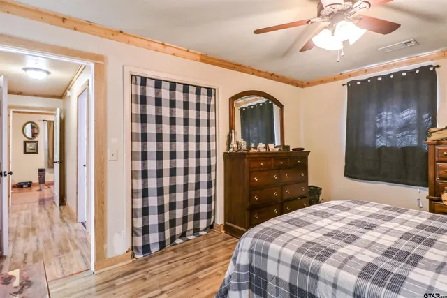 a bedroom with a bed and a dresser