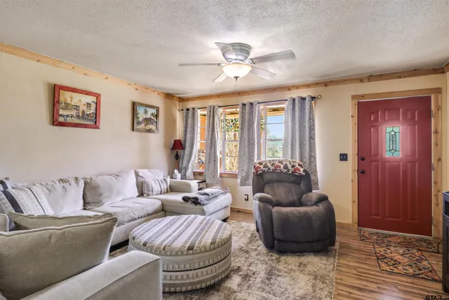 a living room with furniture and large windows