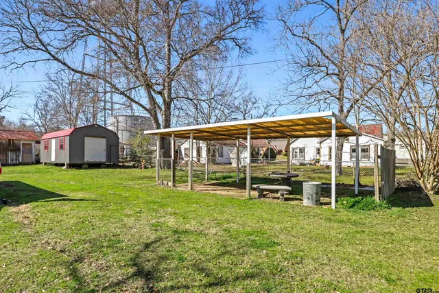a view of a house with a yard and sitting area