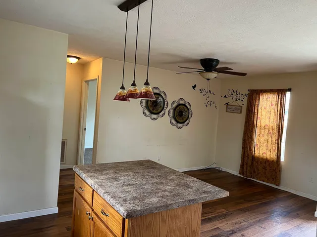 a kitchen with a stove and a wooden floor