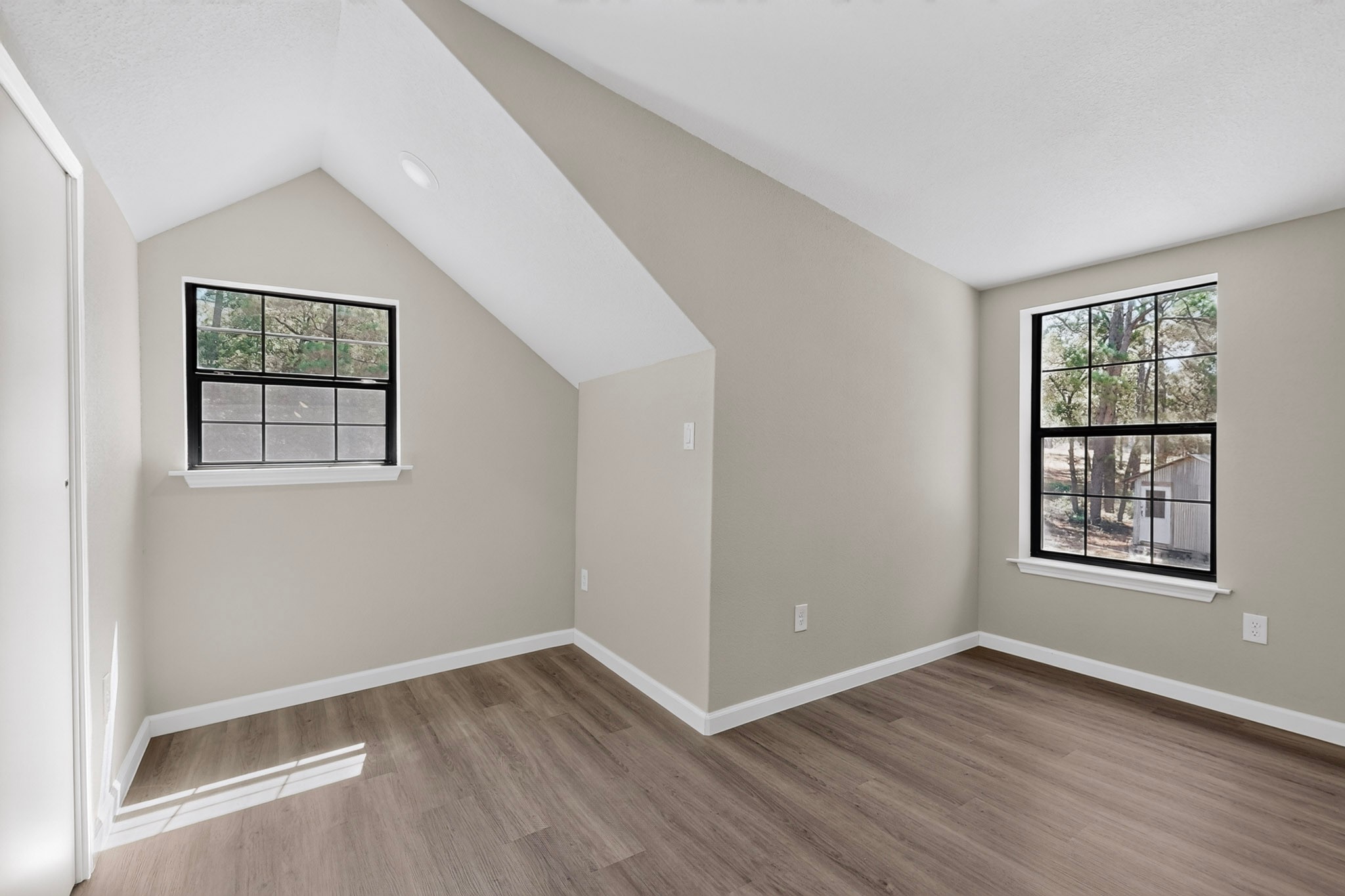 158 Fealy Road Red Rock, TX 78662 - Photo 24 of 40 Vaulted ceilings and wood floors define this bright, versatile bedroom space.